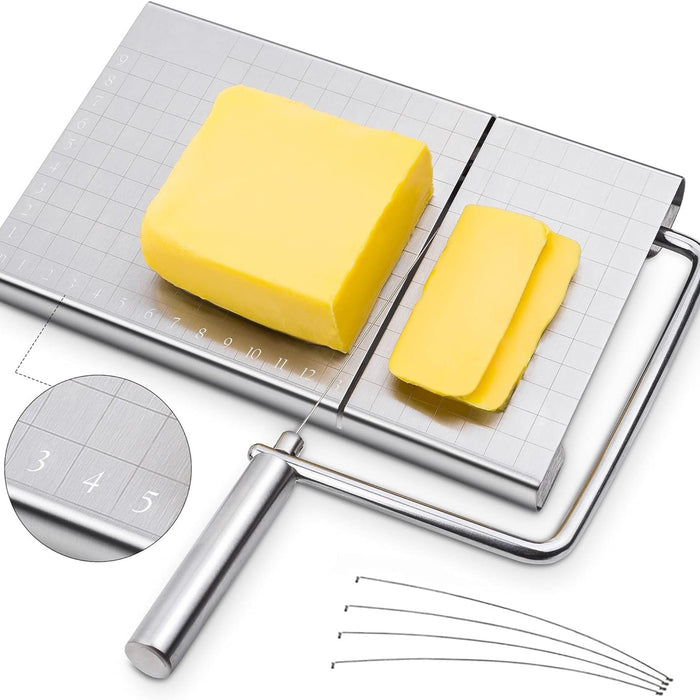 A stainless steel cheese slicer with an ergonomic handle and grid scale, alongside a block of cheese and five replacement wires.