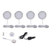 Set of four round LED puck lights with mounting hardware on a white background