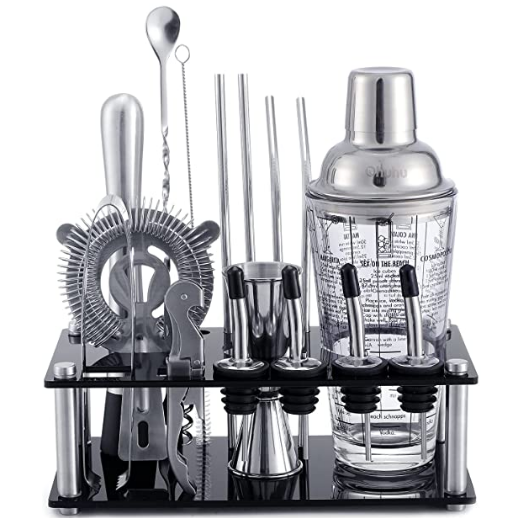 Set of cocktail-making tools including a shaker, jigger, and strainers on a stand.
