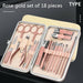 Rose gold manicure set with tools in a case on a black background