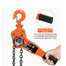 Orange hand chain hoist with black handle and safety cover, held by a hand.