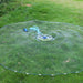 Large fishing net on grass with a blue tool nearby