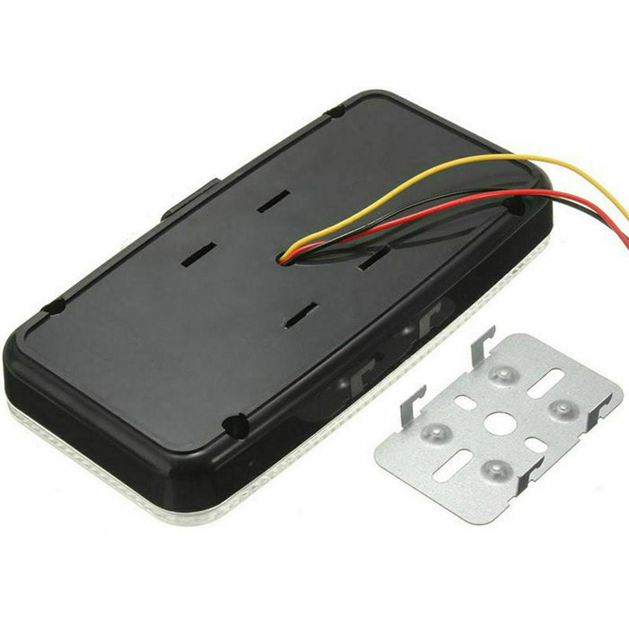 Black electronic component with wires and metal bracket on a white background