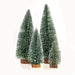 Set of three artificial Christmas trees with snow effects on a white background