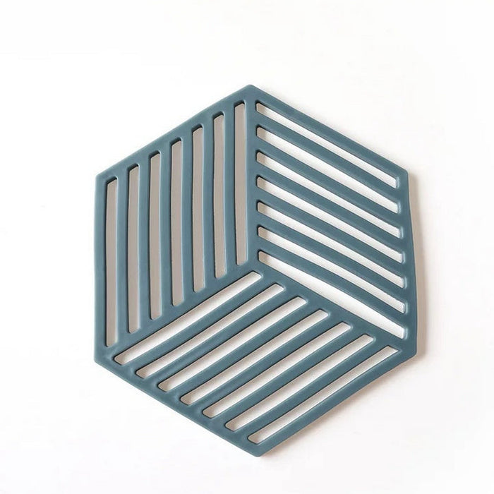 Hexagonal trivet with a geometric pattern on a white background