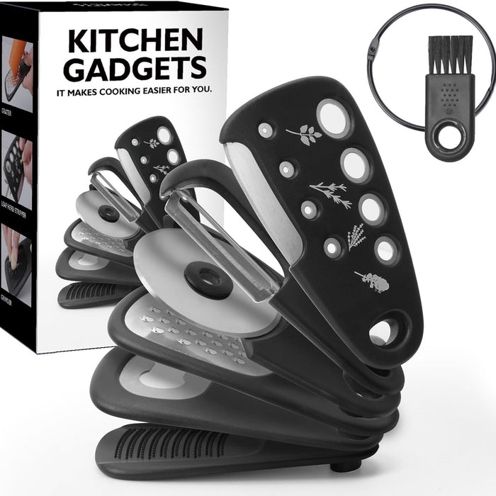 A set of six black kitchen gadgets including a pizza cutter, vegetable peeler, bottle opener, cheese grater, herb stripper, and garlic grinder, displayed with its packaging box and a cleaning brush.
