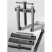 Metal puller tool with components on a gray background