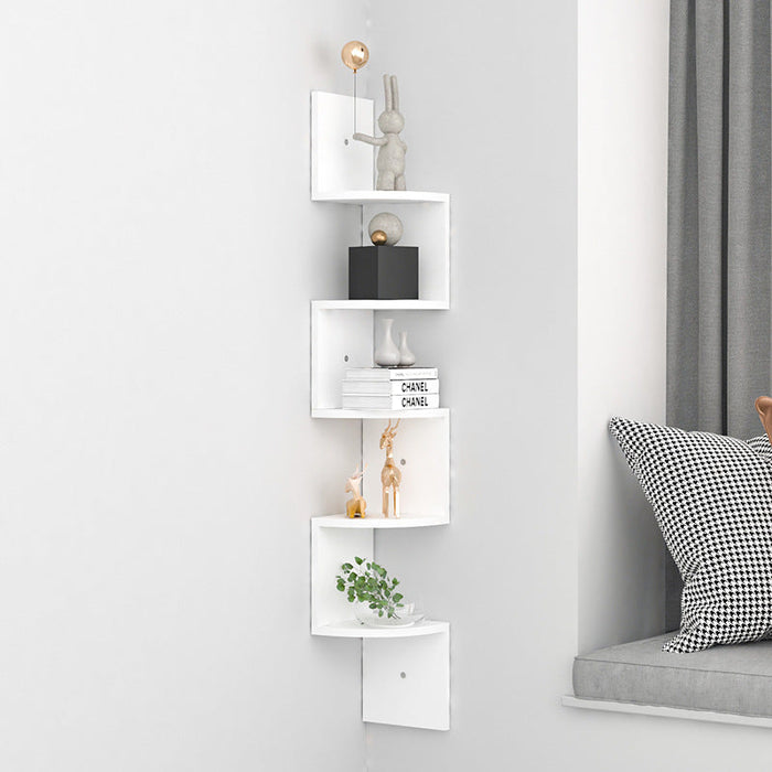 White corner shelf with decorative items against a light gray wall.