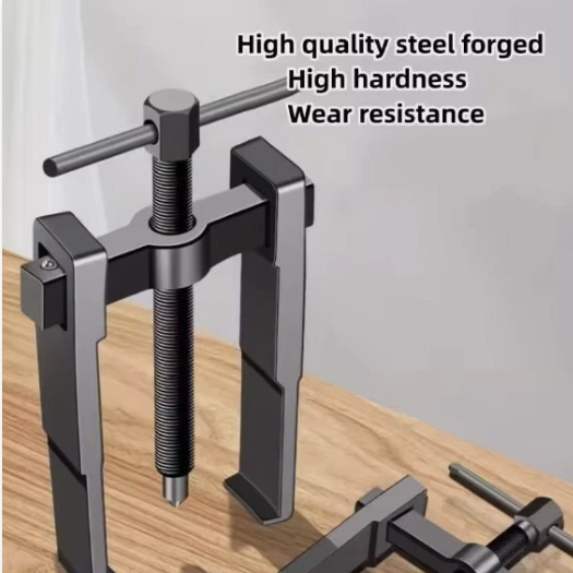 Metal tool with text highlighting high quality steel, hardness, and wear resistance on a wooden surface.