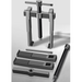 Metal puller tool with components on a gray background