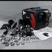 Automotive parts and tools on a gray surface with a branded box.