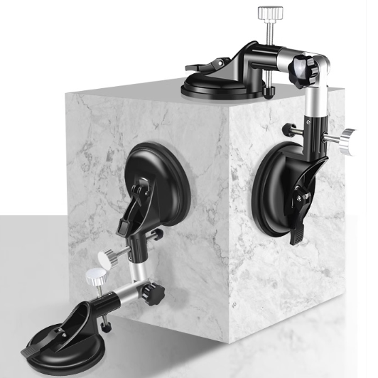 Marble cube with multiple suction cup attachments on a white background