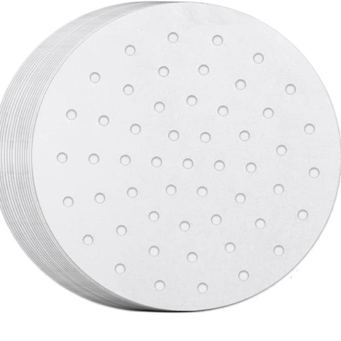 Stack of white paper plates with holes on a white background