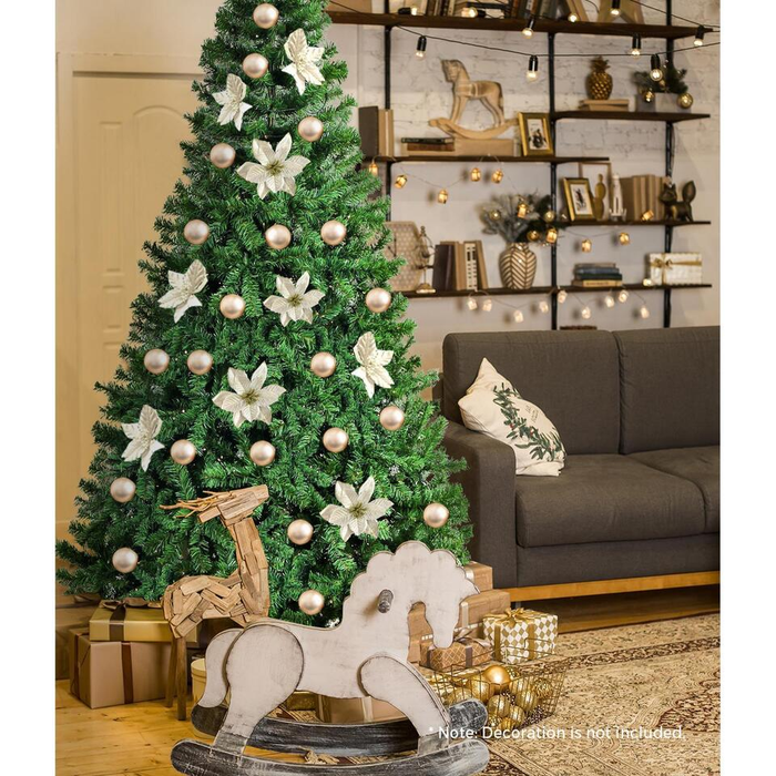 Decorated Christmas tree in a living room with a gray sofa and festive decor.