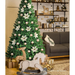 Decorated Christmas tree in a living room with a gray sofa and festive decor.