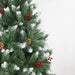 Decorative Christmas tree with green branches, red berries, and pinecones on a white background