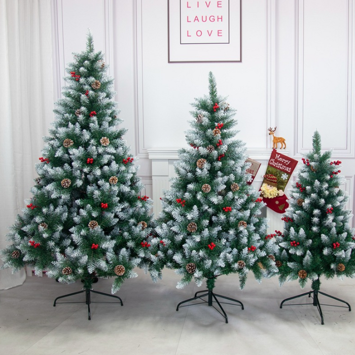 Three decorated Christmas trees in a room with a 'Live Laugh Love' poster on the wall.