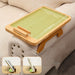 Foldable wooden tray with green surface on a beige couch, showing dimensions and uses.