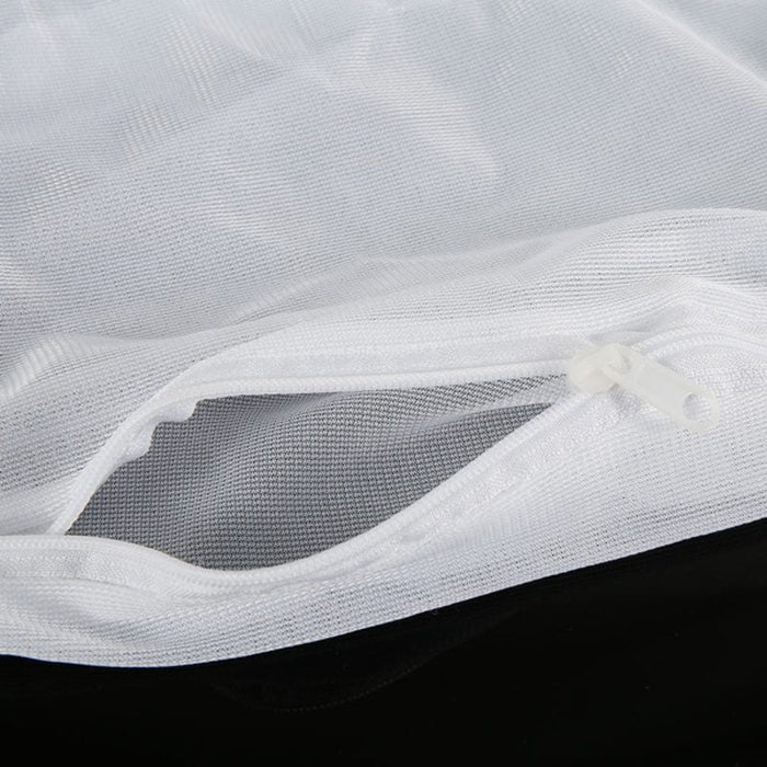Close-up of white mesh fabric with a black background