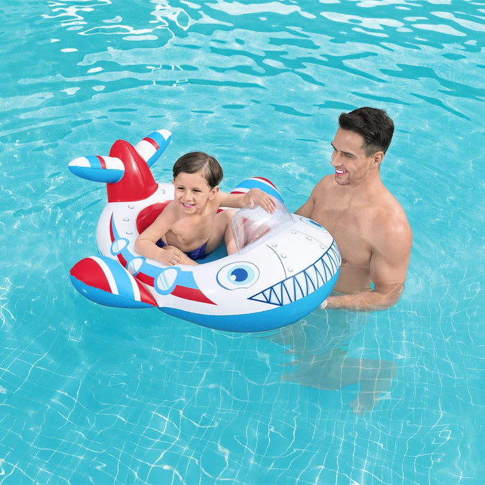 Man and child in a pool with a plane-shaped inflatable ring.