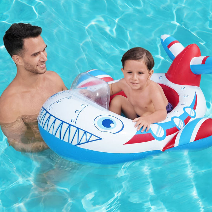 Man and child in a pool with an inflatable plane float.