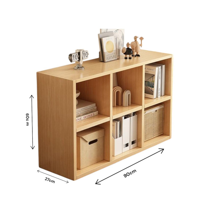 A wooden cubes storage bookcase organizer with multiple compartments, filled with books, decorations, and office supplies.