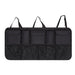 Black car organizer with multiple pockets on a white background