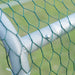 Close-up of a white metal frame with green wire mesh on a blurred green background