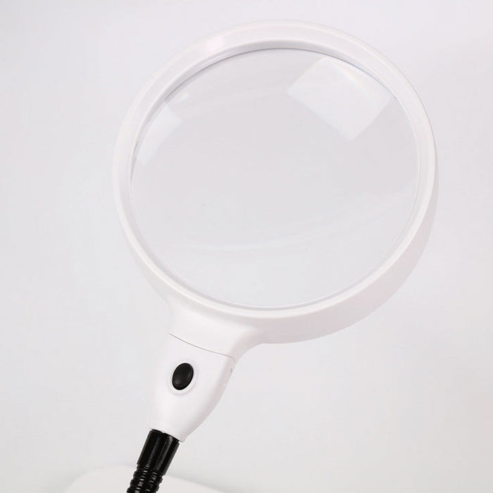 White magnifying glass with black handle on a light gray background