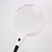 White magnifying glass with black handle on a light gray background