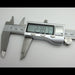 Digital caliper measuring a small round object on a white background