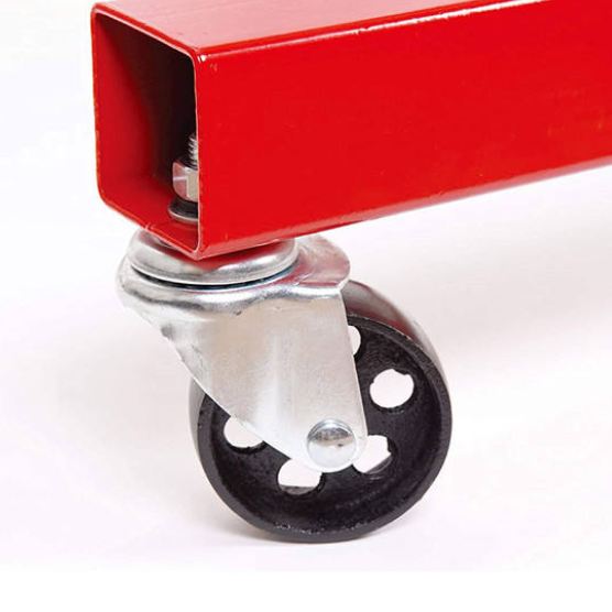 Close-up of a red metal frame with a black wheel on a white background