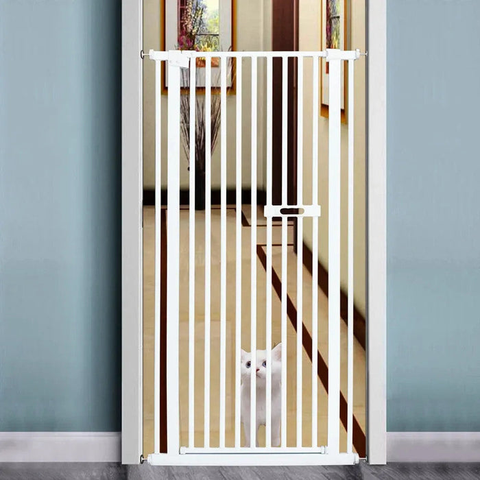 White pet gate in a room with a cat peeking through