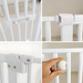White baby gate with a hand holding a ball, demonstrating its size.