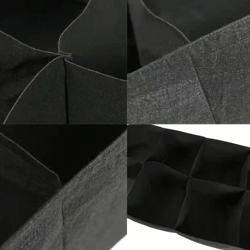 Collage of black fabric with different textures and folds.