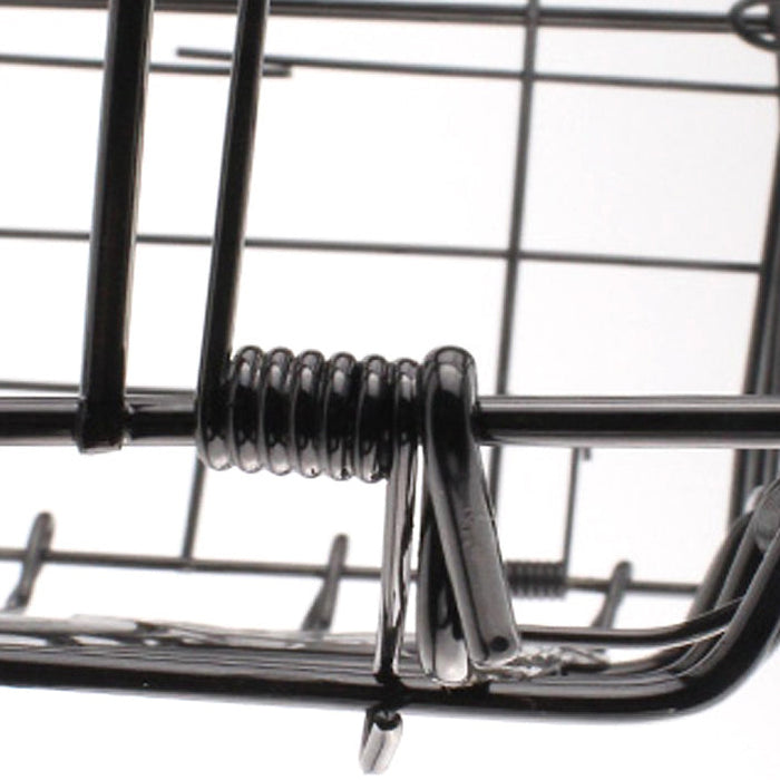 Close-up of a metal trap with a spring mechanism on a white background