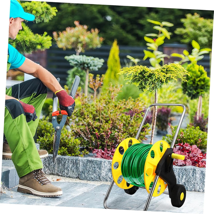 Person gardening with a reel of green cable and tools in a garden setting