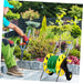 Person gardening with a reel of green cable and tools in a garden setting