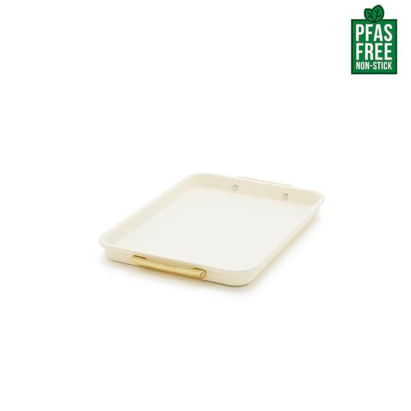 Rectangular baking tray with gold rim on a white background, featuring a PFAS-free label.