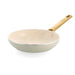 Cream frying pan with a wooden handle on a white background