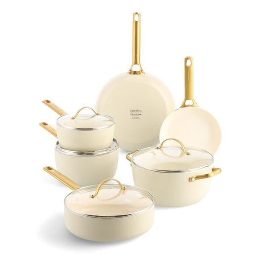 Set of cookware with gold handles on a white background