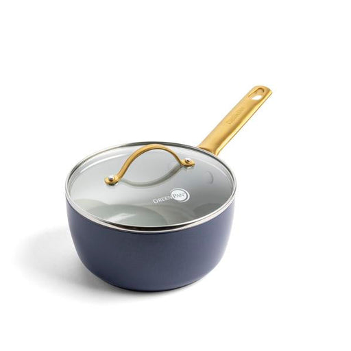 Navy Blue saucepan with a gold handle on a white background