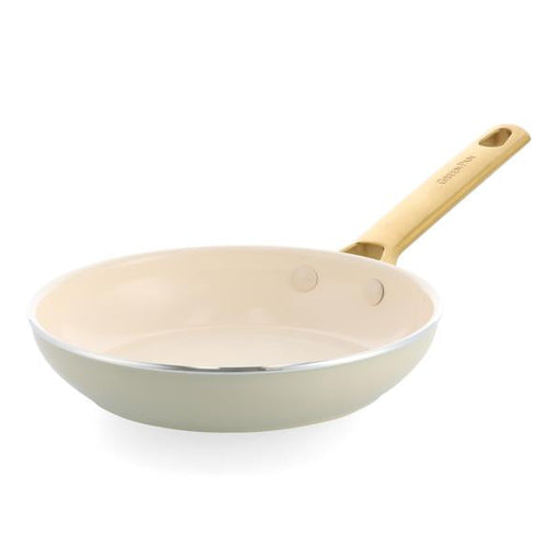 Cream frying pan with a wooden handle on a white background.