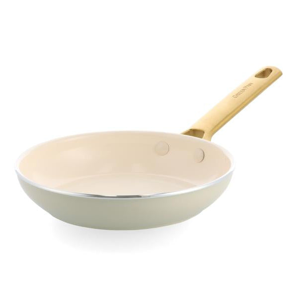 Cream frying pan with a wooden handle on a white background.