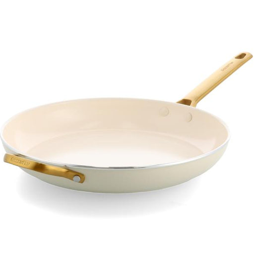 White frying pan with gold handle on a white background