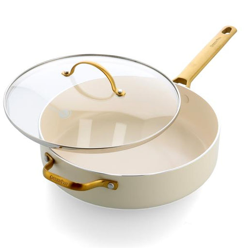 Beige frying pan with gold handles and a clear glass lid on a white background