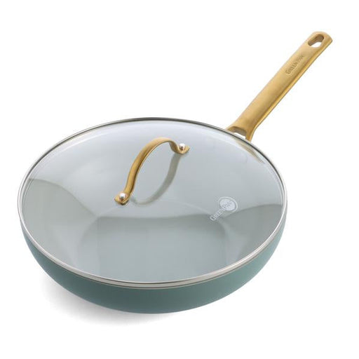 Green frying pan with a glass lid and wooden handle on a white background