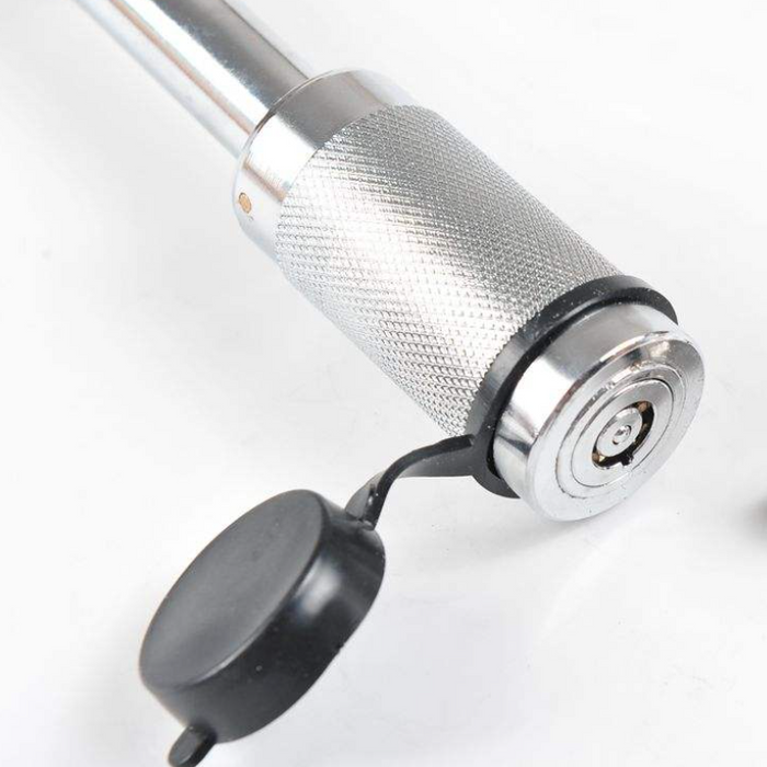 Close-up of a metal tool with a black component on a white background