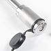 Close-up of a metal tool with a black component on a white background