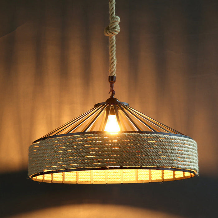 Woven pendant light with a warm glow against a dark background
